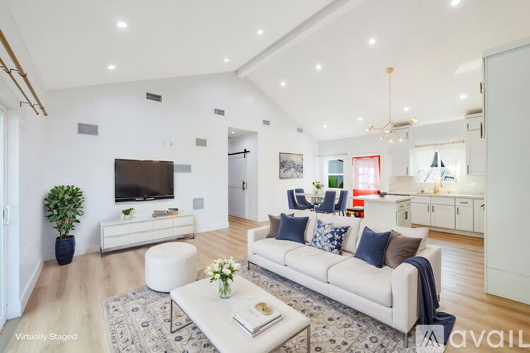 A living room with a white couch and a television.