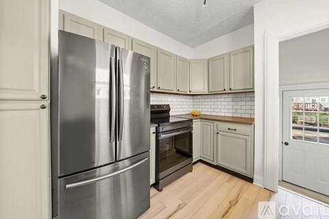 A kitchen with a stainless steel refrigerator and oven.