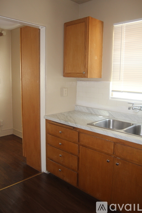 A kitchen with wooden cabinets and a white countertop.