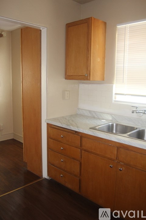 A kitchen with wooden cabinets and a white countertop.