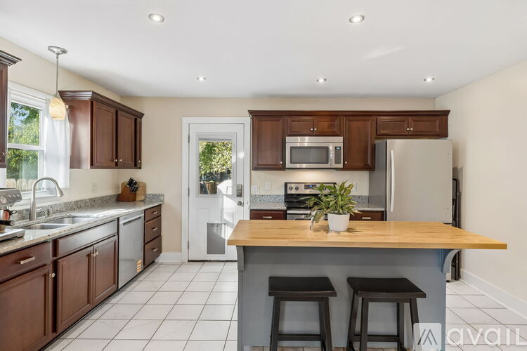 A kitchen with brown cabinets and a white refrigerator.
