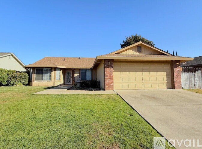 A house with a garage and a driveway is available for sale.