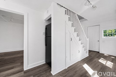 A spacious room with a staircase leading to the upper floor.
