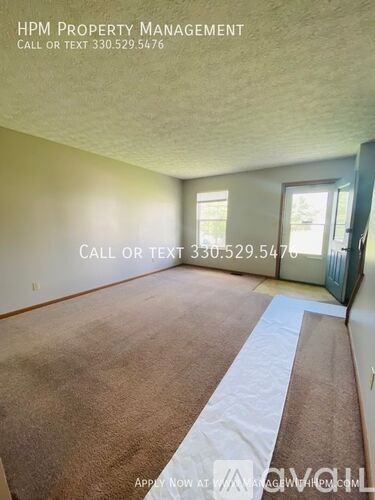 A room with a carpeted floor and a white stripe on the carpet.
