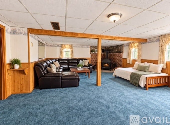A cozy bedroom with a large bed and a comfortable couch.