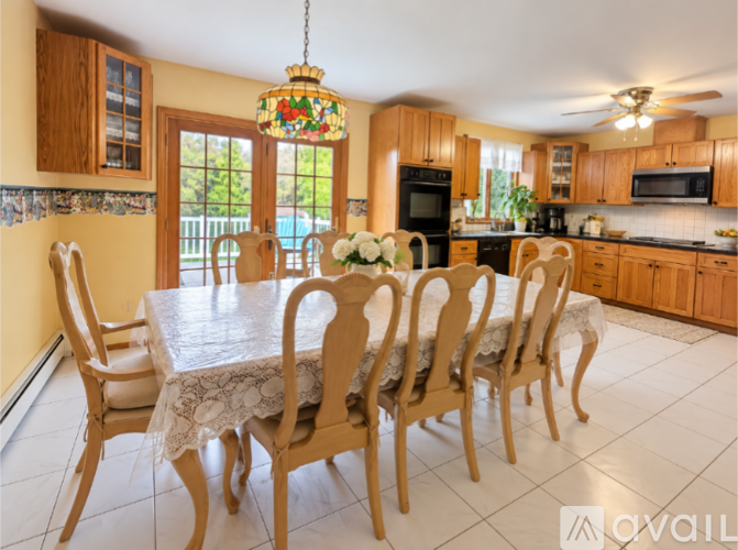 A dining room with a table set for six.