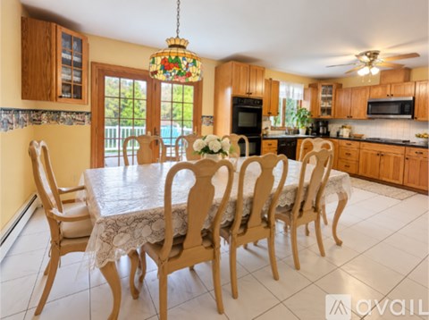 A dining room with a table set for six.