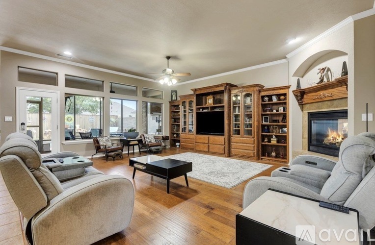 A living room with a fireplace and a television.
