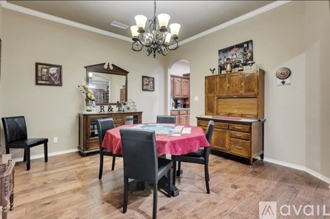 A dining room with a wooden table and chairs.