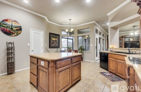 A kitchen with wooden cabinets and a large island.