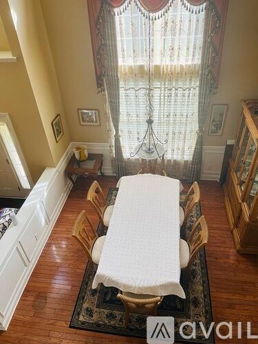 A dining room with a table set for four.
