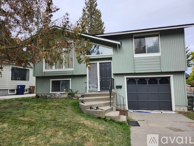 A two-story house with a garage and a front porch.