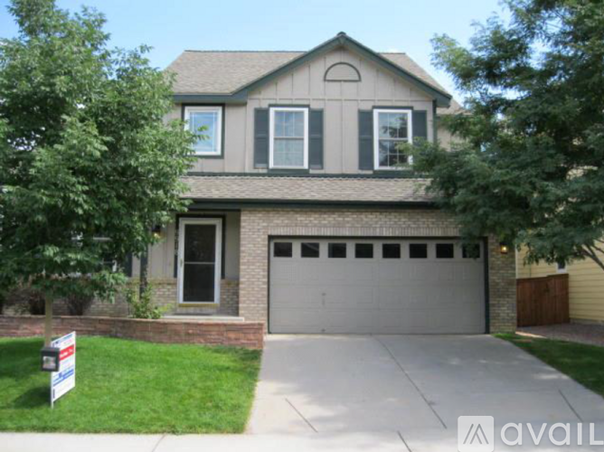 A two-story house with a garage is for sale.