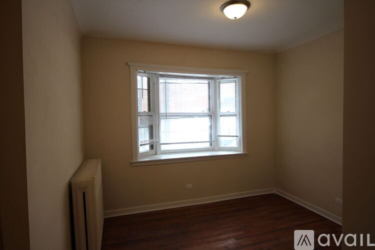 A room with a window and a radiator on the wall.