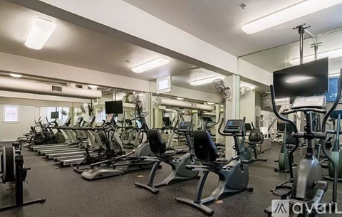 A gym with treadmills, exercise bikes, and other equipment.