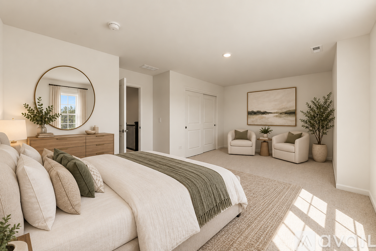 A well-lit bedroom with a large bed and a mirror on the wall.