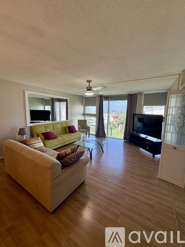 A living room with a couch, a television, and a coffee table.