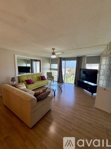 A living room with a couch, a television, and a coffee table.