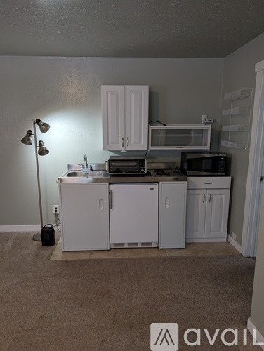 A kitchen with white cabinets and a microwave above the stove.