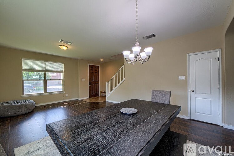A dining room with a wooden table and chairs.
