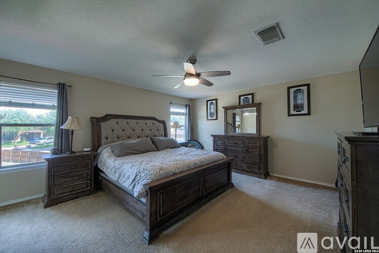 A bedroom with a large bed and a dresser.