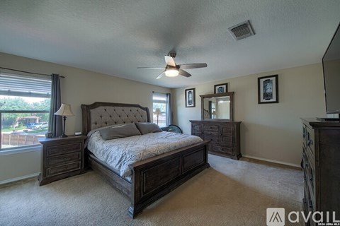 A bedroom with a large bed and a dresser.
