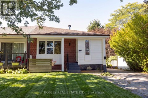 A small house with a red brick exterior and a white door is for sale.