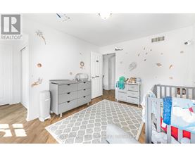 A baby nursery with a crib, dresser, and changing table.