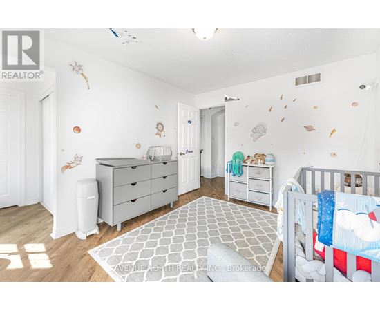 A baby nursery with a crib, dresser, and changing table.
