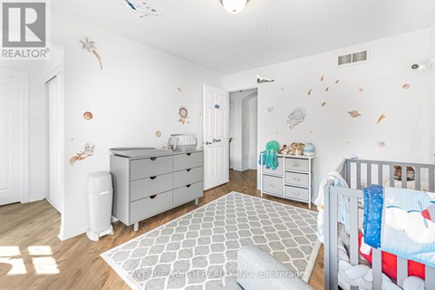 A baby nursery with a crib, dresser, and changing table.