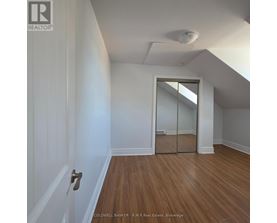 A room with a wooden floor and white walls.
