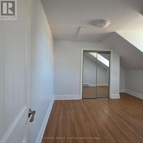 A room with a wooden floor and white walls.