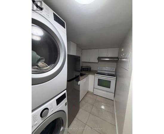 A small laundry room with a washer and dryer.