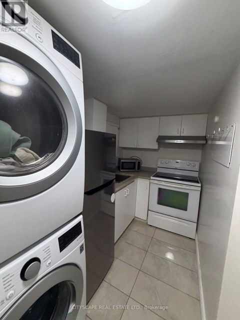 A small laundry room with a washer and dryer.