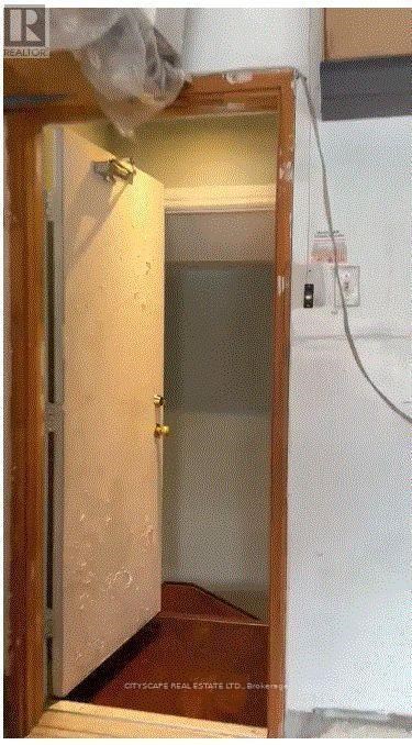 A small, unfinished room with a door and a window.