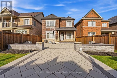 A row of houses with a stone walkway in front.