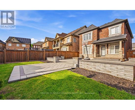 A sunny day in a suburban neighborhood with a house and a yard.