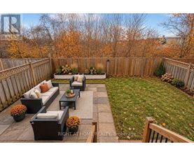 A backyard with a patio and a fence.