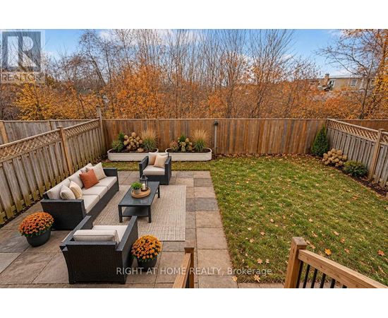 A backyard with a patio and a fence.