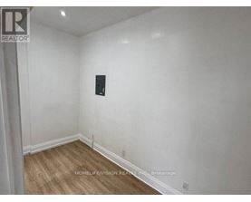 A room with a wooden floor and white walls.