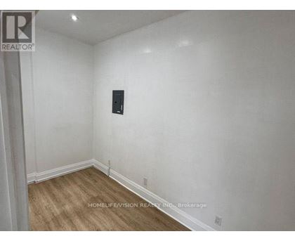 A room with a wooden floor and white walls.