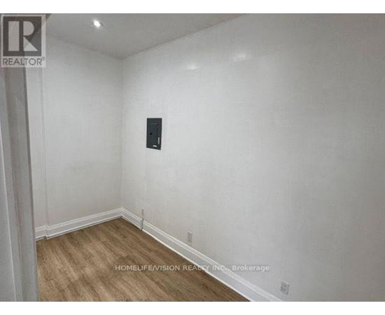 A room with a wooden floor and white walls.