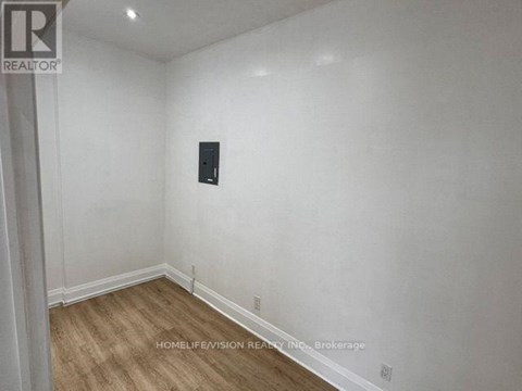 A room with a wooden floor and white walls.
