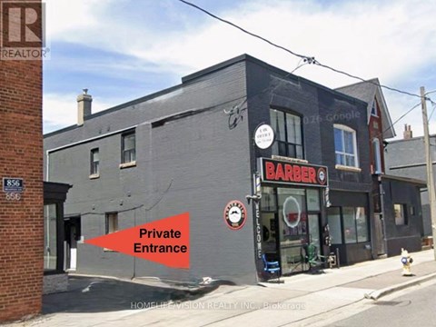 A barber shop with a sign that says Barber.