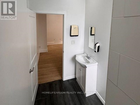 A bathroom with a sink and a mirror on the wall.