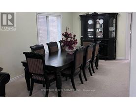 A dining room with a table set for six.