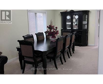 A dining room with a table set for six.