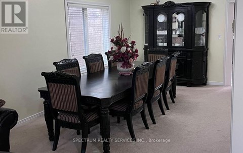 A dining room with a table set for six.
