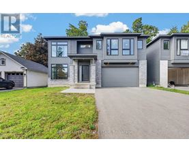 A modern two-story house with a garage is for sale.