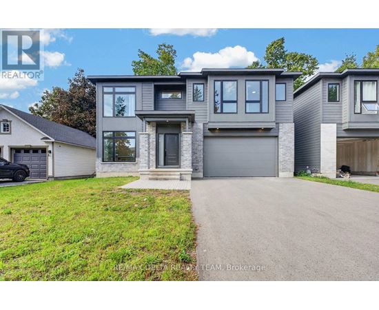A modern two-story house with a garage is for sale.